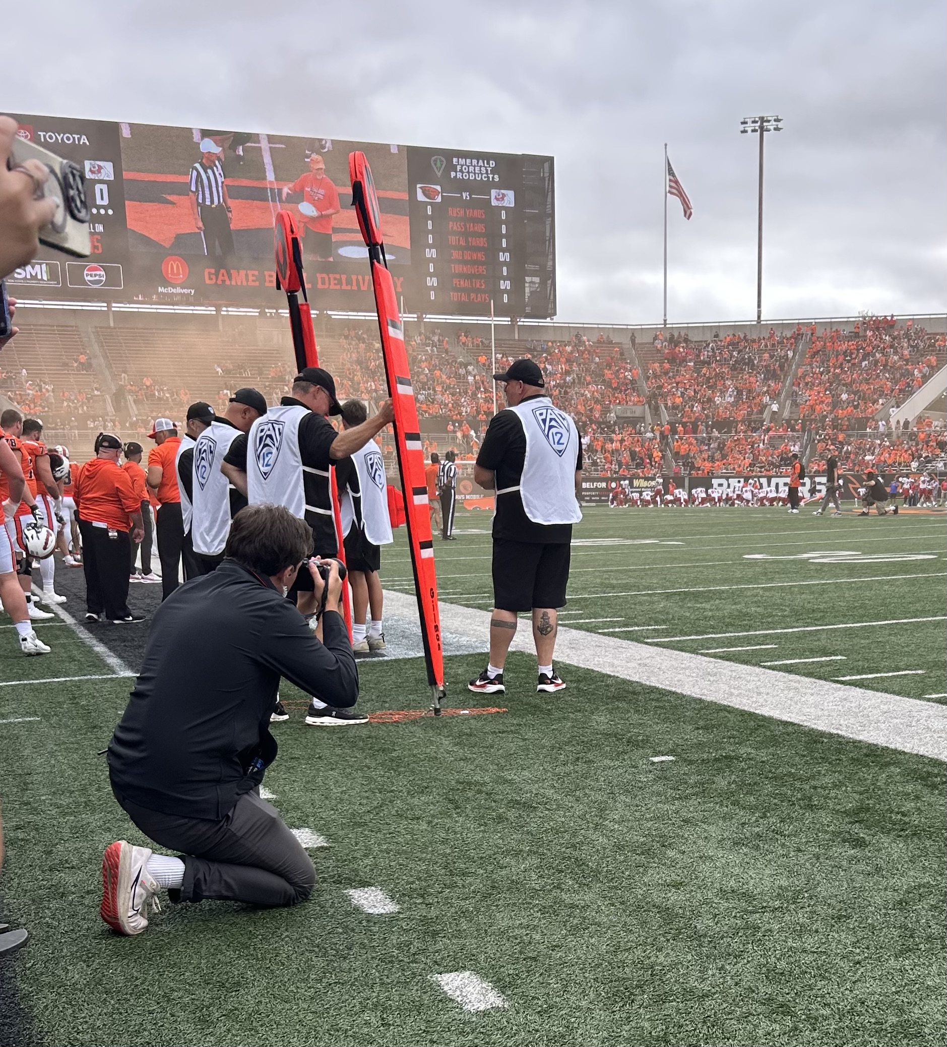 Hogan shooting sideline photography at an OSU football game